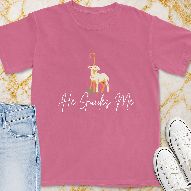 Pink t-shirt with a lamb and staff graphic, and the words "He Guides Me".