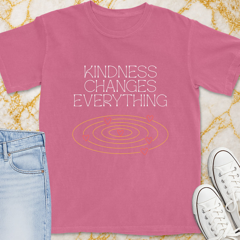 Pink t-shirt with "Kindness Changes Everything" text and heart design.