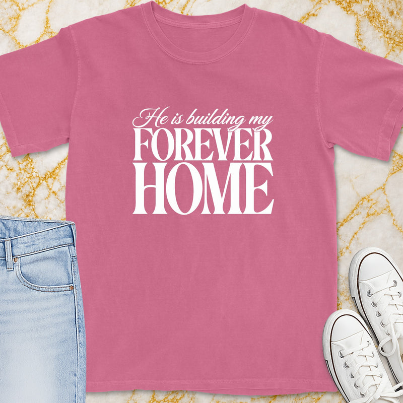 Pink t-shirt with white text "He is building my FOREVER HOME".