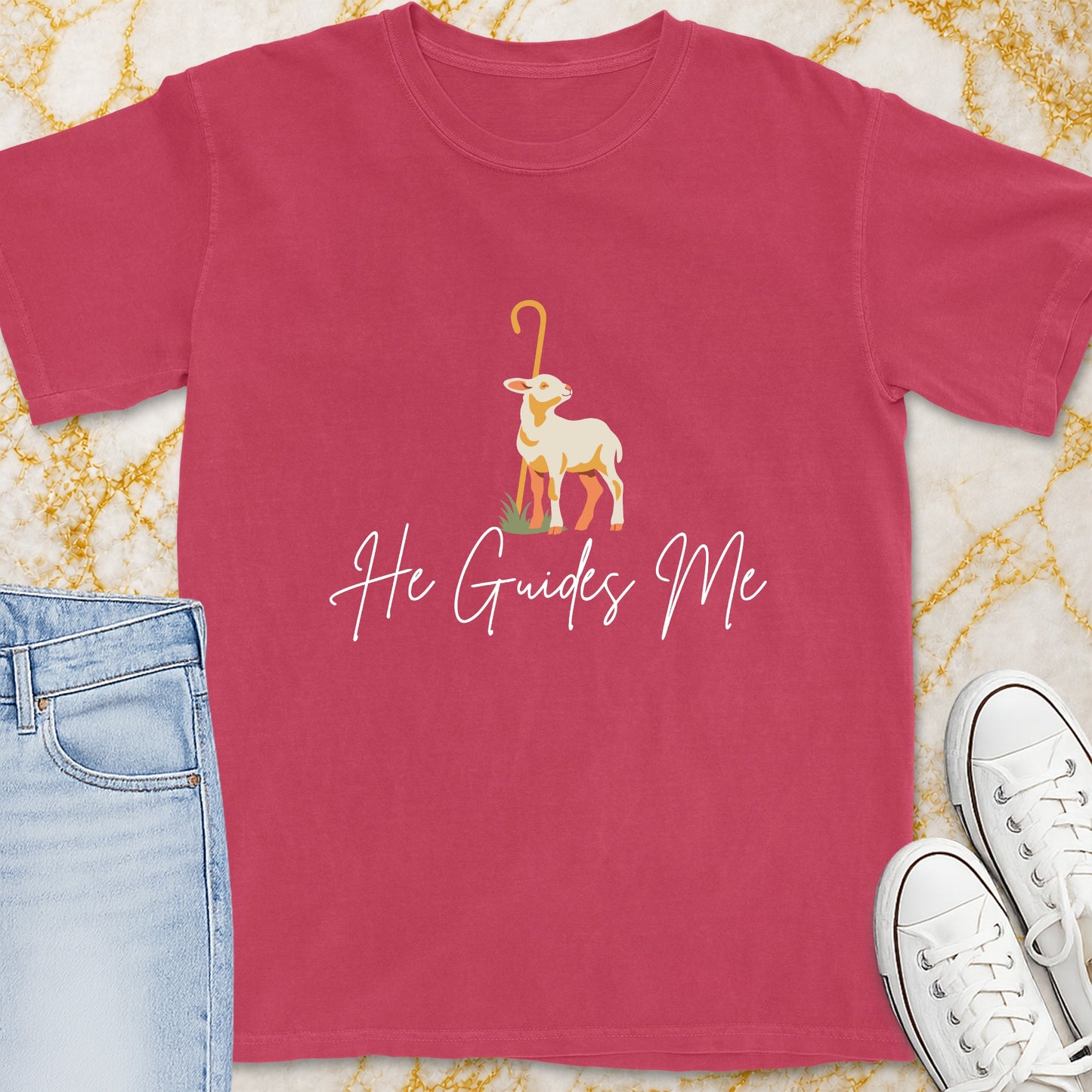 Pink t-shirt with a lamb and shepherd's crook graphic and text "He Guides Me".