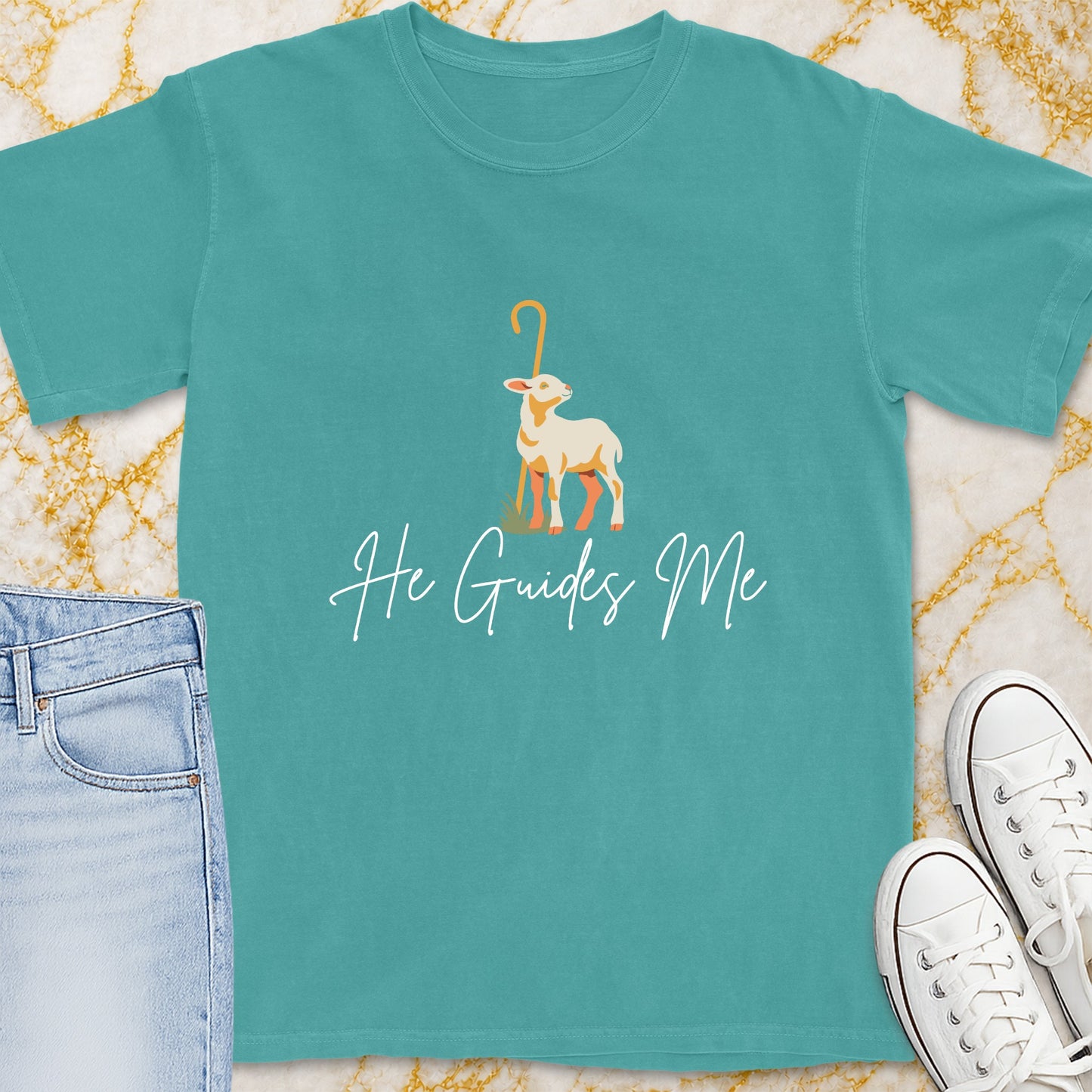 Teal t-shirt with a graphic of a lamb and shepherd's crook, saying "He Guides Me".