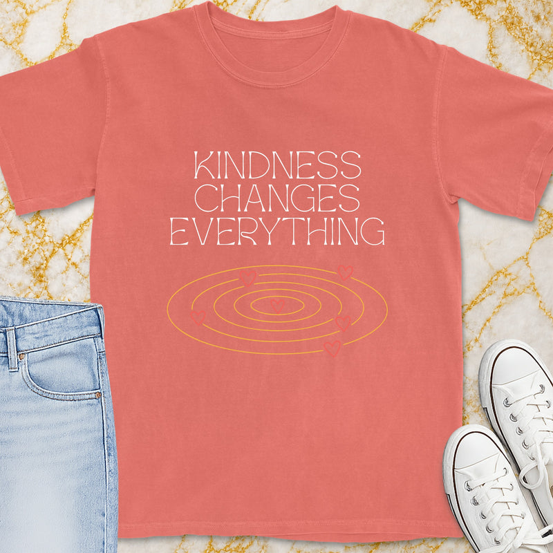 Coral t-shirt with "Kindness Changes Everything" text and heart graphic.