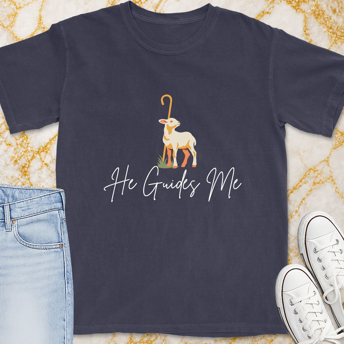 Dark t-shirt with a graphic of a lamb and text "He Guides Me."
