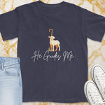 Dark t-shirt with a graphic of a lamb and text "He Guides Me."