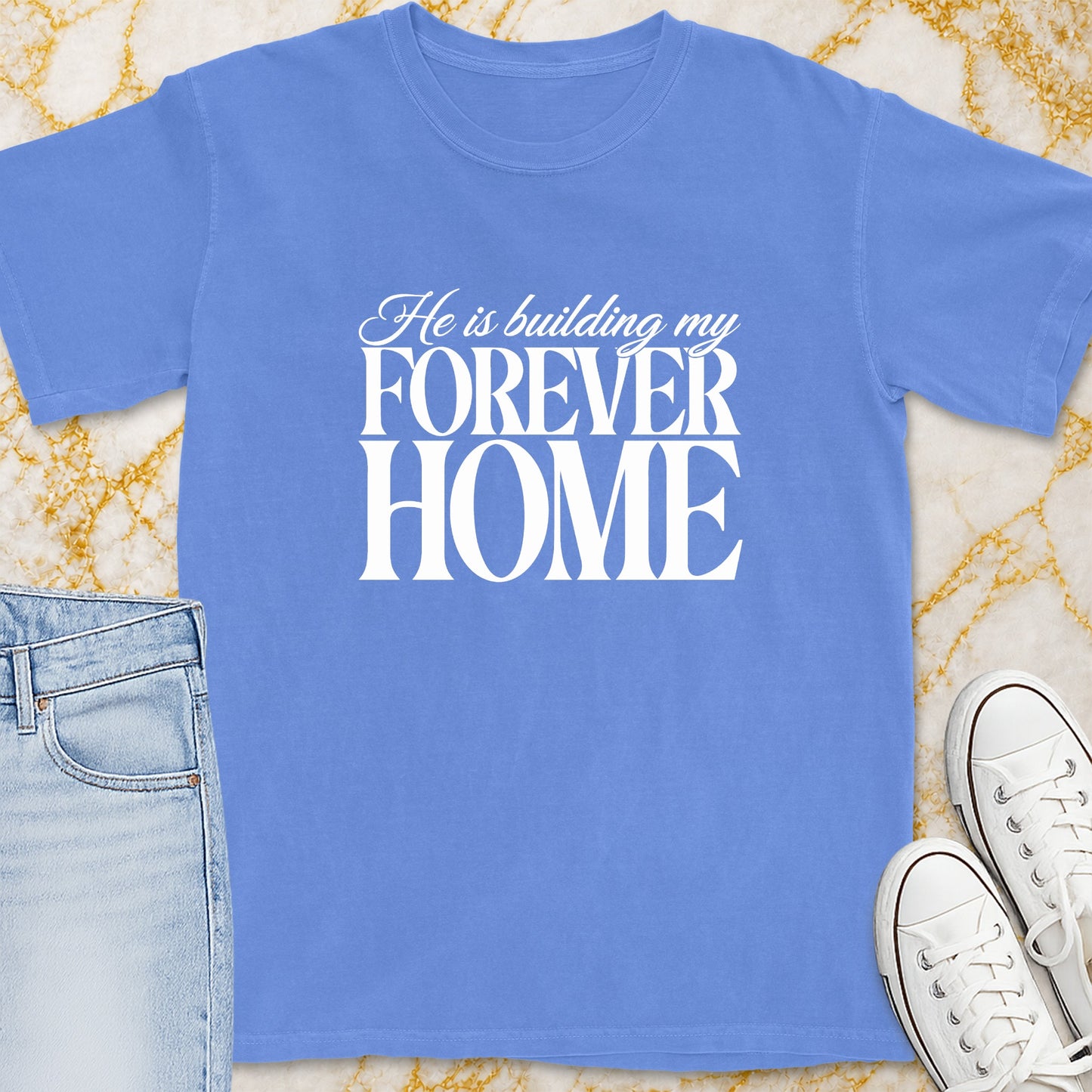 Blue t-shirt with white text "He is building my FOREVER HOME"