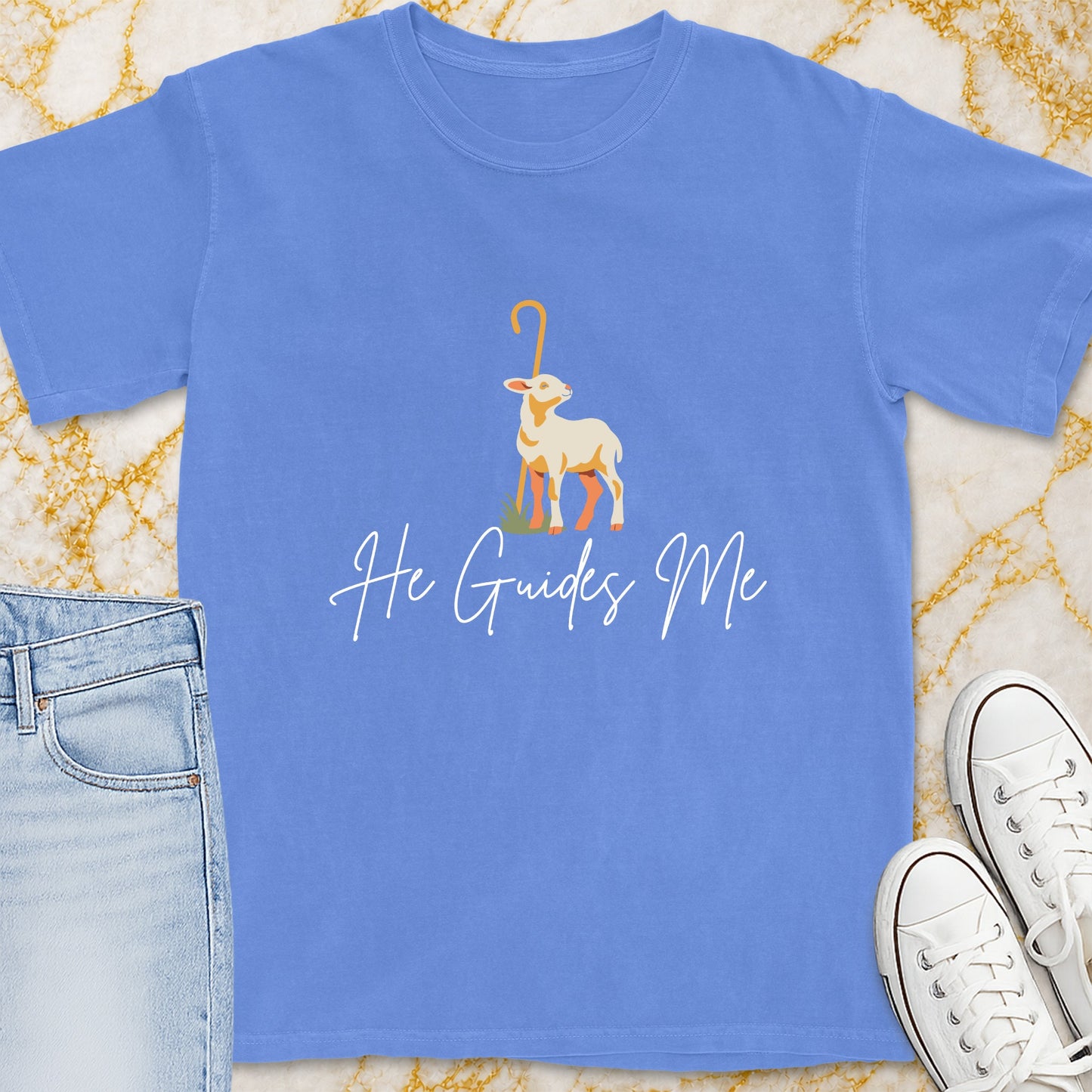 Blue t-shirt with a graphic of a lamb and the text "He Guides Me".