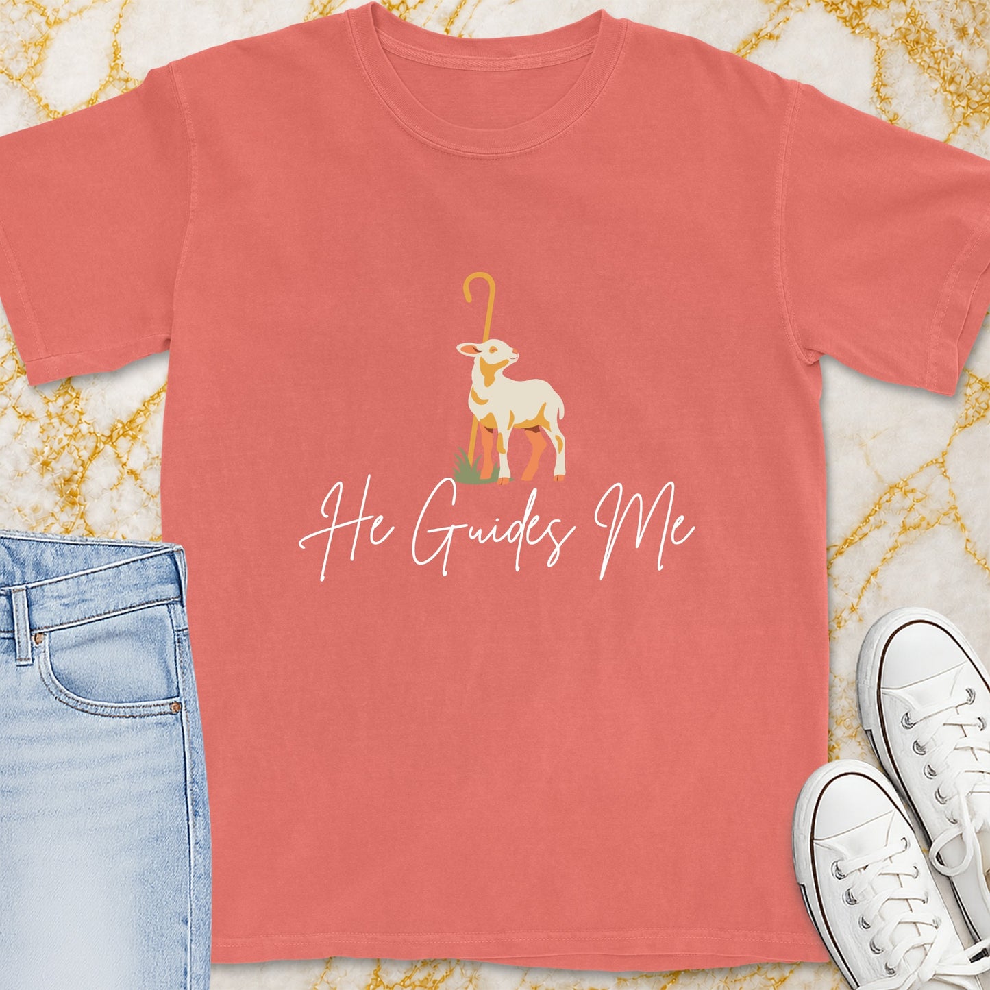 Coral t-shirt with a lamb graphic and "He Guides Me" text.