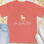 Coral t-shirt with a lamb graphic and "He Guides Me" text.