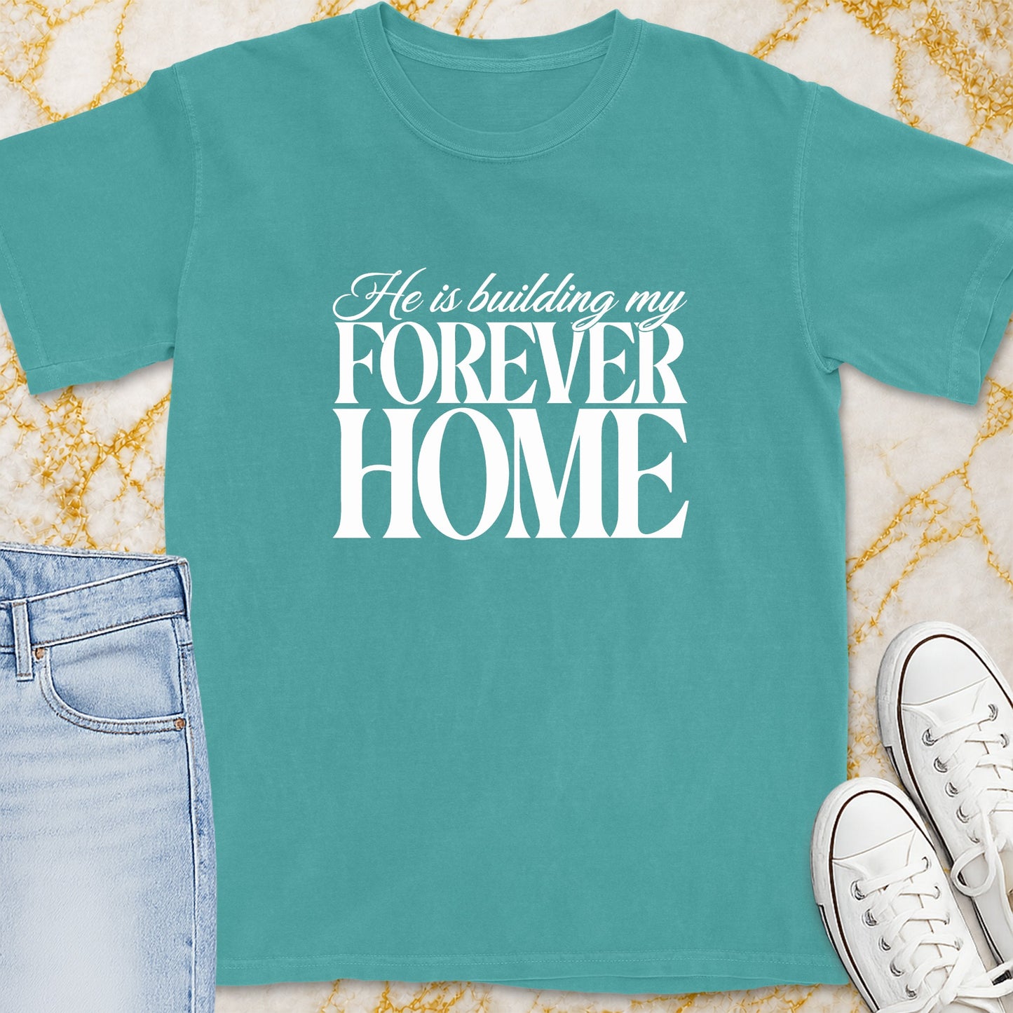 Teal t-shirt with white text "He is building my FOREVER HOME".