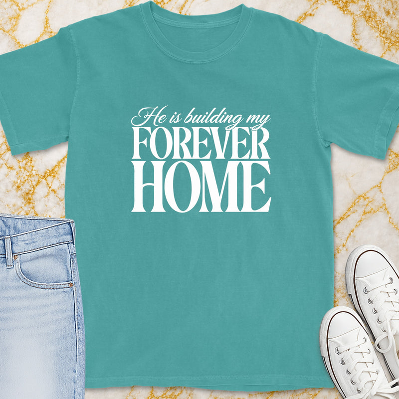 Teal t-shirt with white text "He is building my FOREVER HOME".