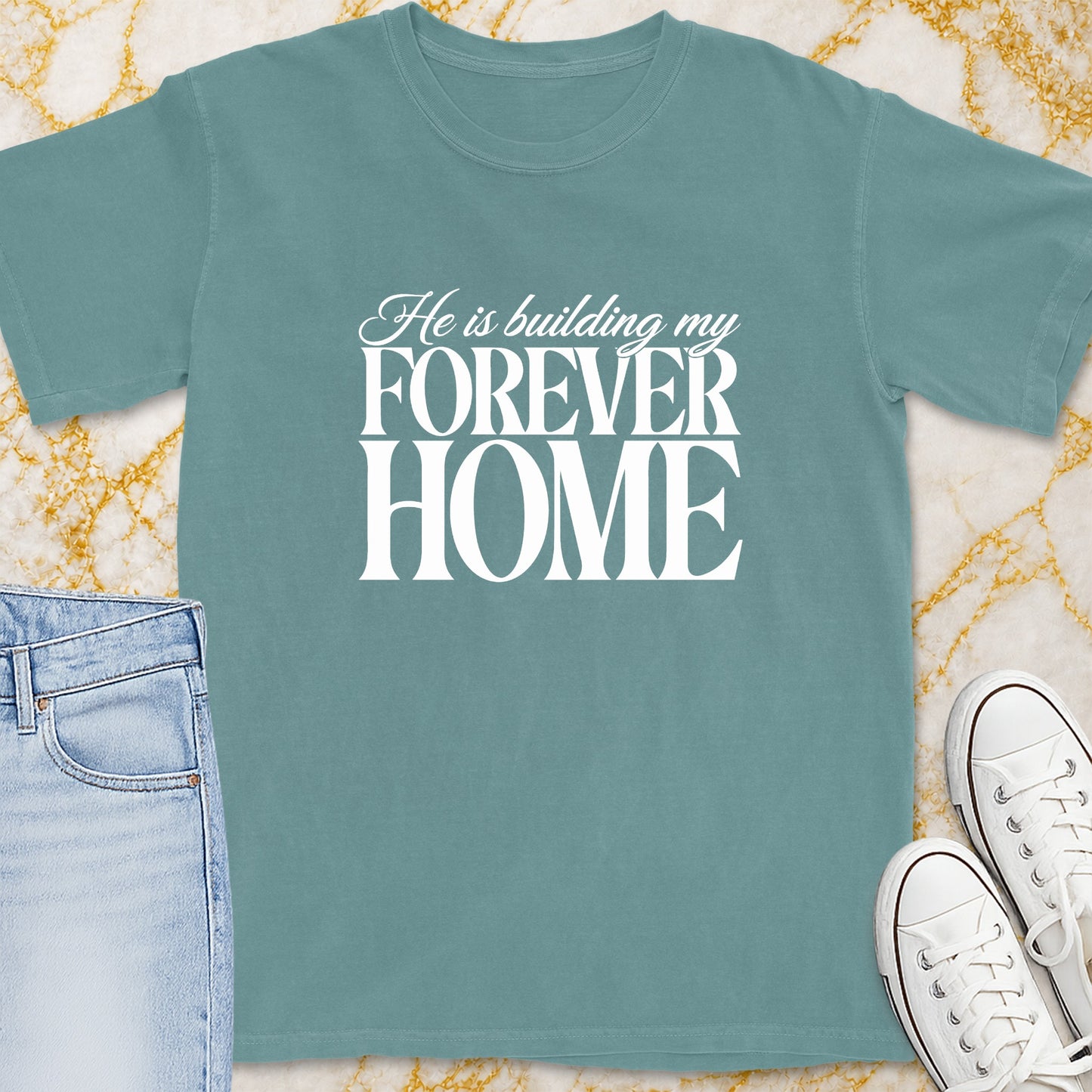 Teal t-shirt with white text "He is building my FOREVER HOME".