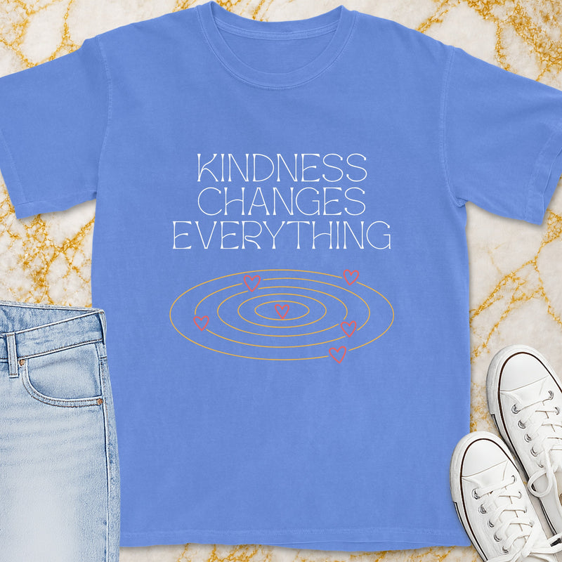 Blue t-shirt with "Kindness Changes Everything" text and swirling hearts graphic.